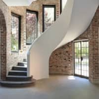 <p>A sculltural staircase leads up to Glencliff&#x27;s second floor.</p>
