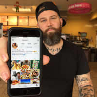 <p>Matt Savage of Garfield displays his Instagram in a Lodi Dunkin Donuts.</p>