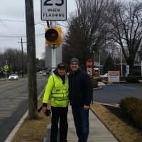 <p>Paramus Mayor Rich LaBarbiera and a crossing guard pose with the new solar-powered LED system installed at several crosswalks in the borough.</p>