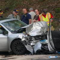 <p>First responders investigate the crash scene at Rive Road and Mt. Pleasant Road in Shelton on Wednesday.</p>