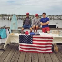 <p>The founders of Fair Harbor -- Sam Jacobson, Caroline Danehy, and Jake Danehy -- sell their wares on a dock in the Fire Island town of the same name last summer.</p>