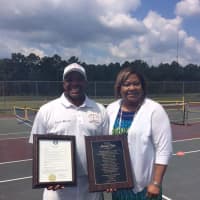 <p>Marvin Tyler of Slammer Tennis World in Norwalk stands with the Mayor of Emporia, Va., Mary Person. The town recently honored Tyler for his contributions to the sport.</p>