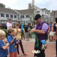 <p>An expert delights the kids as he makes balloon animals and hats at the Slice of Saugatuck festival in Westport.</p>