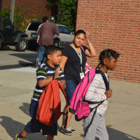 <p>Backpack in hand, students head into South Street School in Danbury on Monday for the first day of school. </p>