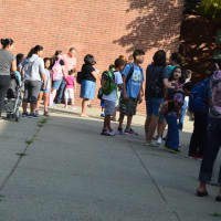 <p>Kids line up for the first day of school at South Street Elementary in Danbury on Monday. </p>