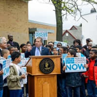 <p>Yonkers Mayor Mike Spano, at podium, speaks at a rally for a schools rebuilding project in front of the Martin Luther King Jr. Academy Wednesday morning.</p>
