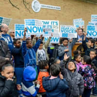 <p>Students at the Martin Luther King Jr. Academy hold signs Wednesday supporting legislation that would approve the first phase of a schools rebuilding project.</p>