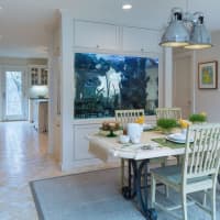 <p>Separating the kitchen and dining room is a beautiful fish tank.</p>