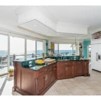 <p>The granite top counters offer a view into the backyard.</p>