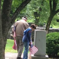 <p>Guiseppe &quot;Joe&quot; Tanzi, said to be the region&#x27;s sole surviving Pear Harbor veteran, helps Ari Kotler place flags at the veterans memorial in Patriot&#x27;s Park on Memorial Day.</p>