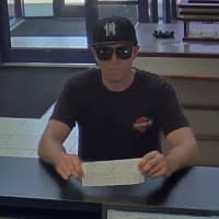 <p>New York State Police are looking for this bank robbery suspect, seen on camera, who allegedly passed a note to a teller at TD Bank in Fishkill demanding money.</p>