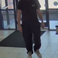 <p>The bank robbery suspect is shown, on camera, walking into TD Bank midday Sunday.</p>