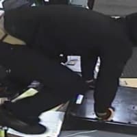 <p>Armed robber leaps counter.</p>
