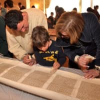<p>Members of the Reform Temple of Rockland look at Torah scrolls. Temple Beth El in Spring Valley, which recently combined its congregation with that of Temple Beth Torah in Nyack, will be moving its Torahs to the new location this Sunday.</p>