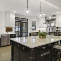 <p>The kitchen offers custom cabinetry and new appliances.</p>