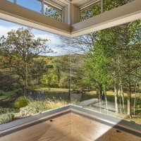 <p>Overlooking the private lake on the property is one of many perks of 54 Old Stone Hill Road.</p>