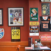<p>The walls are filled with sports memorabilia at Tigers&#x27; Den in Ridgefield.</p>