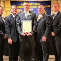 <p>Detective Dmitriy Mazur, center, recieves a Gold Valor Award last year with Deputy Chief Rob Guidetti, second from left, Chief Kenneth Ehrenberg, second from right, and other PBA officials.</p>