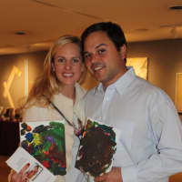 <p>Chip and Cameron Buzzeo of New Canaan show off artwork created by their twins, Harper and Sophie at the Tiny Miracles Foundation&#x27;s World Prematurity Day event.</p>