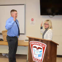 <p>Tommy Robbins, a graduate of Danbury High School, takes the oath of office at the Brookfield Police Department. He begins training this week.</p>