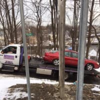 <p>The car that was hit by a Danbury-bound train on Tuesday afternoon is towed from the scene of the accident in Norwalk.</p>