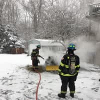 <p>Firefighters put out a tractor fire on Purdy Hill Road in Monroe on Saturday</p>