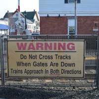 <p>A sign at the train station in downtown Ramsey gives a safety warning to pedestrians, which some have been ignoring.</p>