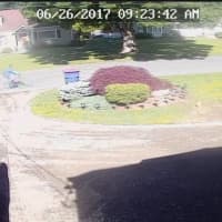 <p>Surveillance footage of a suspect in a pair of home burglaries in Trumbull on Monday. The suspect is described as a white, possibly Hispanic, male on a bicycle</p>