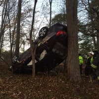 <p>A car flipped over and its engine caught fire after a crash in Trumbull on Monday</p>