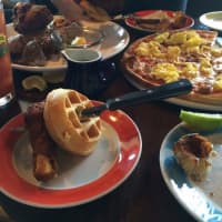 <p>The Twisted Elm Tavern makes two brunch pizzas, one with sausage and eggs (rear, right) and the other with smoked salmon.</p>