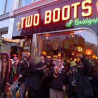 <p>Two Boots customers party outside the downtown Bridgeport restaurant. The popular food and music venue closed its downtown Bridgeport location this week due to financial struggles.</p>