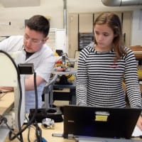 <p>Bronxville Middle School technology teacher Greg Di Stefano helps a student use a woodcarving machine to create a board game.</p>