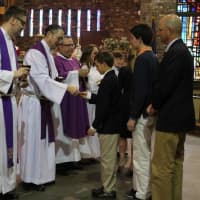 <p>Oliver Nordahl receives his First Holy Communion with his family at Village Lutheran Church.</p>