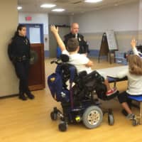<p>Police Officer Cheryl Jarosz and Sgt. William Carroll talk to Bronxville Elementary School students about safety on Halloween. </p>