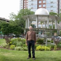 <p>Artist R. M. Fischer in front of his sculpture, Twilight of Dawn, in Ruby Dee Park at Library Green, New Rochelle.</p>