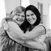 <p>Amy Persico hugs her mother who bought her first camera.</p>