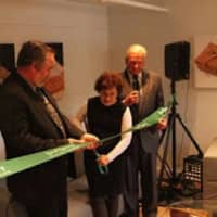 <p>Pleasantville ribbon cutting with Owner Helene Godin holding the scissors.</p>