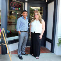 <p>Holly Sharpe and Hossain Ahmed outside their candy store, Pop Culture, in Harrison.</p>