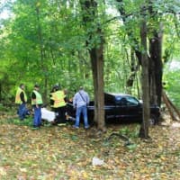 <p>Firefighters, EMT&#x27;s and EMStar medic make a plan for moving the driver of the truck across uneven terrain.</p>