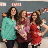 <p>Wendy Leynse (center) receives flowers to mark her last year as an ACS Eats! event organizer. Pictured with her are event organizers Erin Scordo (l) and Jamie Sclafane (r).</p>