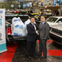 <p>Eastchester Chrysler Jeep Dodge director Alan Katz (right) with coats collected for New York Cares Coat Drive.</p>