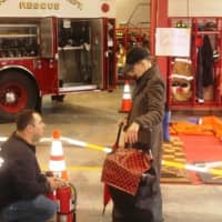 <p>Firefighter Jim Scanga answers a resident&#x27;s question about household fire extinguishers</p>
