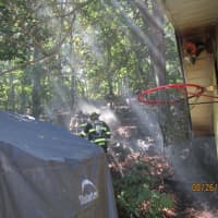 <p>Firefighters battle a brushfire in Mahopac.</p>