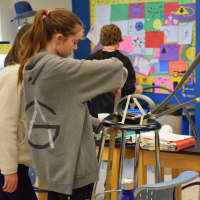 <p>Using foam tubing, a marble, tape and foam cups for support, the students worked in groups to design their roller coasters.</p>