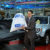 <p>Eastchester Chrysler Jeep Dodge director Alan Katz with coats collected for New York Cares Coat Drive.</p>