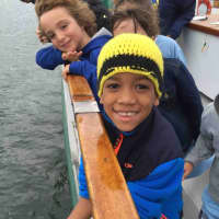 <p>Bronxville Elementary School&#x27;s Vladimir Sanchez is about to release a squid back into the Long Island Sound. Second-grader Andrew Eiref (blue sweatshirt) is looking on.</p>