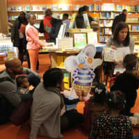 <p>Ann Marie Gilligan, a third-grade teacher at Traphagen Elementary School, read to book fair attendees.</p>