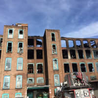 <p>Yonkers firefighters remained at the scene of the former Alexander Smith Carpet building into the afternoon following Monday morning&#x27;s fire.</p>