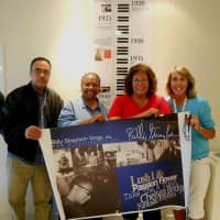 <p>The panel for &quot;Strayhorn: An Illustrated Life,&quot; an exhibit celebrating the life of jazz pioneer Billy Strayhorn, is displayed by, from left, designer Jesse Sanchez; co-curators Leslie Demus and Theresa Kump Leghorn; and art teacher Laura Heiss.</p>