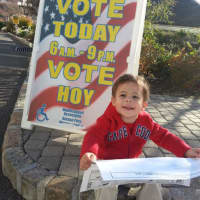 <p>3-year-old Jeremy Shiff evaluating a sample ballot before his father heads to vote in Hartsdale.</p>
